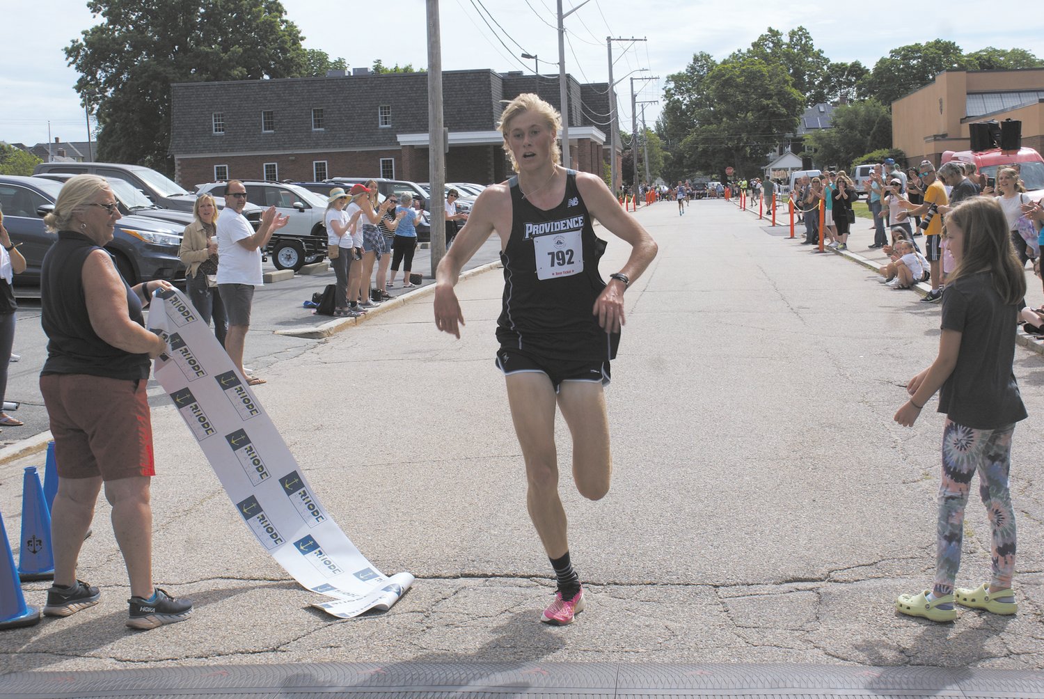 CROSSING THE FINISH LINE: Providence College sophomore Liam Back finished in first place with a time of 14:38. (Photo by Steve Popiel)